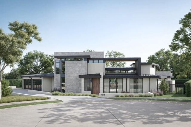 view of front of home with a standing seam roof, fence, and metal roof