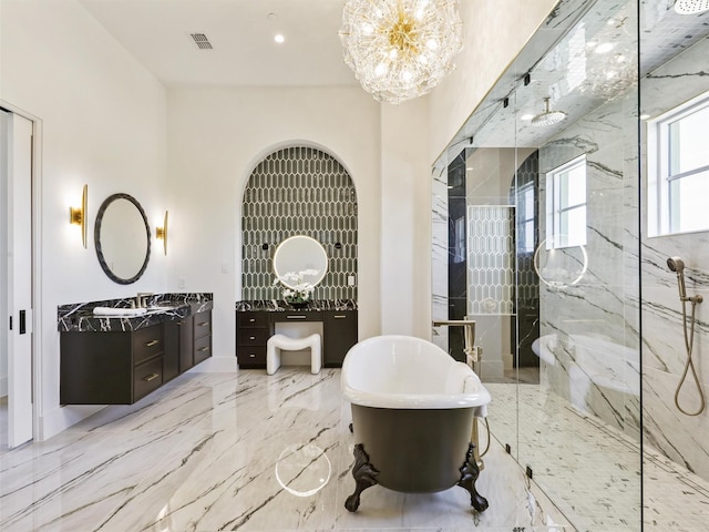 bathroom featuring a marble finish shower, a chandelier, a soaking tub, marble finish floor, and vanity