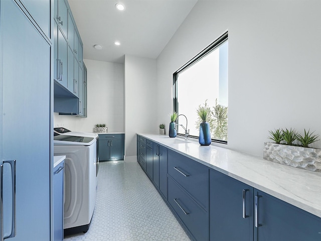 laundry room with washer and clothes dryer, recessed lighting, cabinet space, and a sink