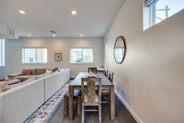 dining space featuring plenty of natural light, visible vents, baseboards, and wood finished floors