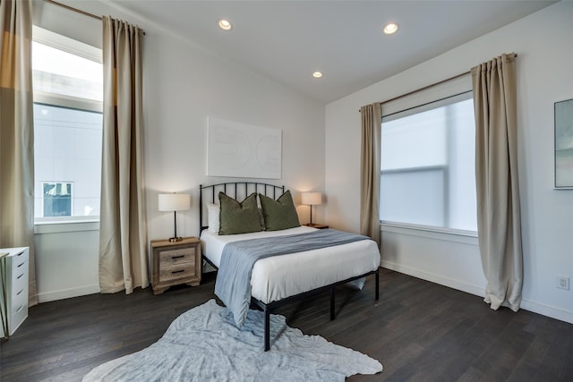 bedroom with multiple windows, dark wood finished floors, and recessed lighting