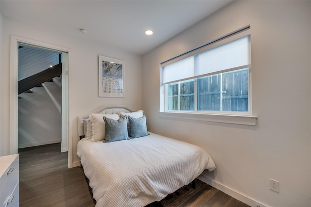 bedroom with dark wood-style floors, baseboards, and recessed lighting