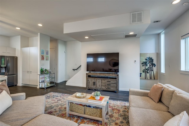 living area featuring dark wood-type flooring, visible vents, and recessed lighting