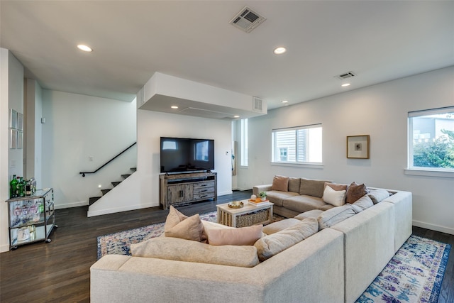 living area with stairs, visible vents, dark wood-type flooring, and recessed lighting