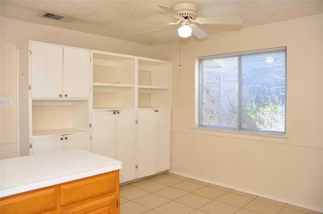 kitchen with a textured ceiling, visible vents, and a wealth of natural light