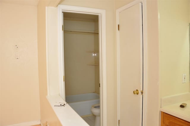 bathroom featuring tub / shower combination, toilet, and tile patterned floors