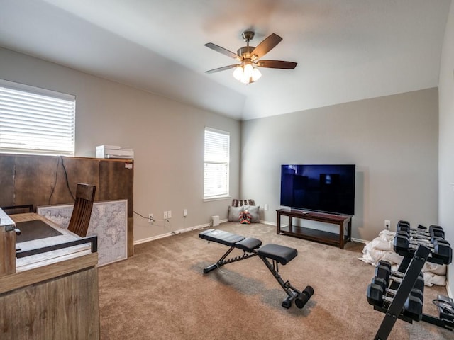 exercise area featuring baseboards, lofted ceiling, ceiling fan, and carpet floors