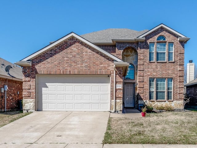 traditional home featuring brick siding, an attached garage, roof with shingles, and driveway