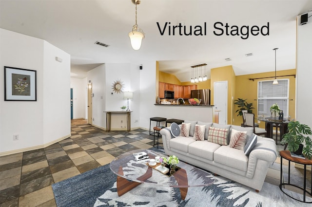 living room featuring visible vents, lofted ceiling, and baseboards