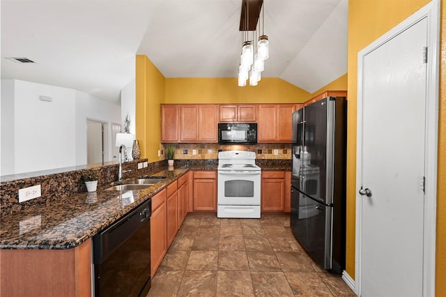 kitchen featuring pendant lighting, decorative backsplash, dark stone countertops, black appliances, and a sink