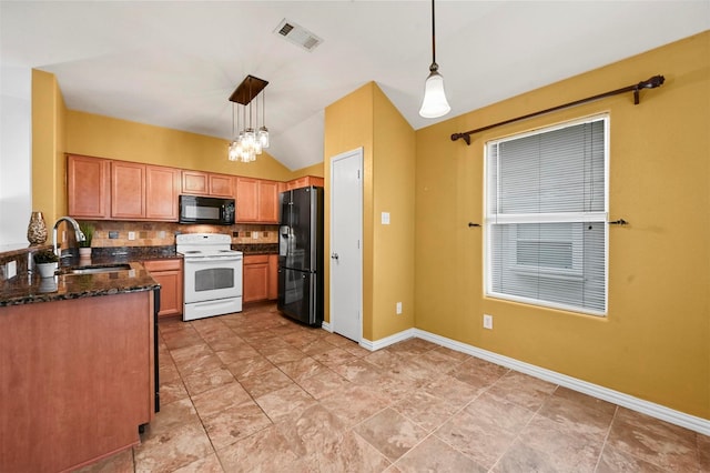 kitchen featuring baseboards, visible vents, a sink, hanging light fixtures, and black appliances