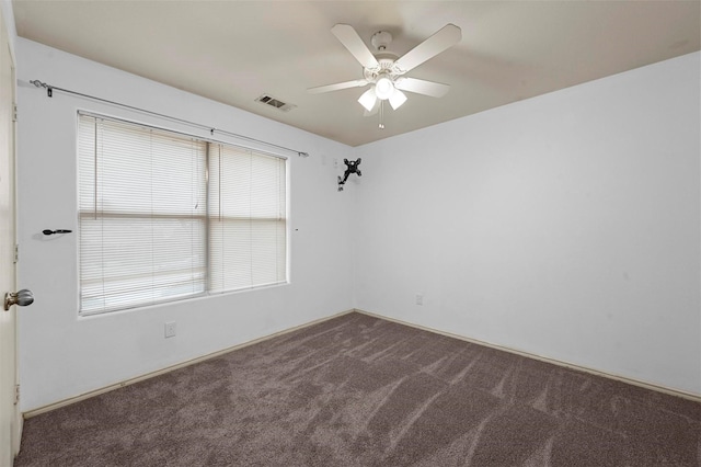 unfurnished room with visible vents, ceiling fan, and carpet flooring