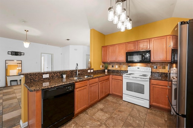 kitchen featuring dark stone countertops, a sink, hanging light fixtures, black appliances, and tasteful backsplash