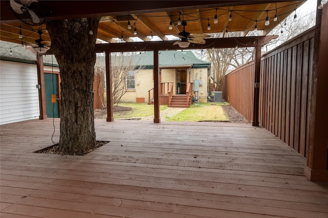 wooden terrace featuring ceiling fan, fence, and cooling unit