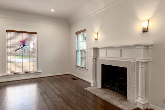 unfurnished living room with recessed lighting, dark wood-type flooring, visible vents, baseboards, and a tiled fireplace