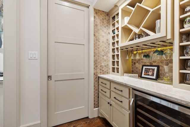 bar with a dry bar, tasteful backsplash, wine cooler, and dark wood-type flooring