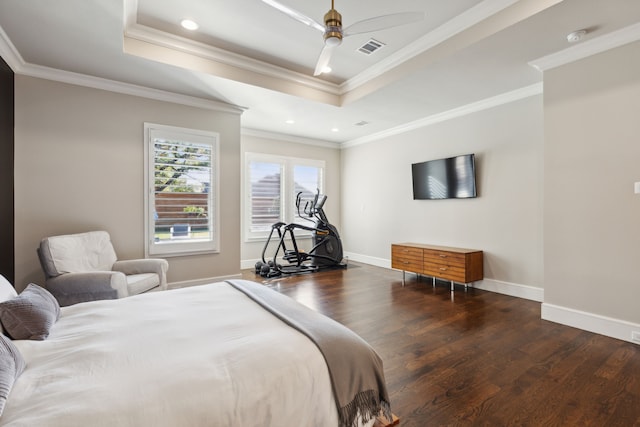 bedroom with crown molding, baseboards, a raised ceiling, and wood finished floors