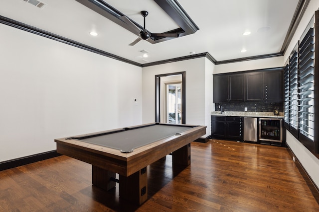 recreation room with beverage cooler, dark wood-style floors, a wealth of natural light, and wet bar