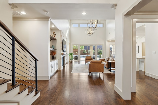 entrance foyer featuring baseboards, dark wood-style floors, stairway, a chandelier, and recessed lighting