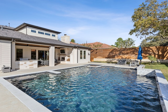 view of pool featuring exterior kitchen, a fenced backyard, a fenced in pool, and a patio