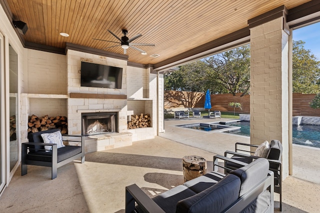 view of patio / terrace featuring a fenced backyard, an outdoor stone fireplace, ceiling fan, and a fenced in pool