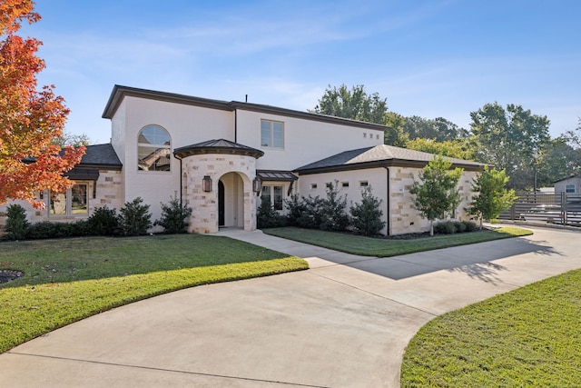 view of front of house with stone siding and a front yard