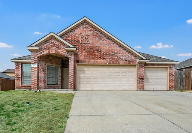 view of front of house with a garage, fence, concrete driveway, and brick siding