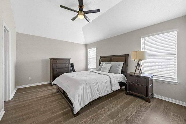 bedroom featuring dark wood-style floors, ceiling fan, vaulted ceiling, and baseboards