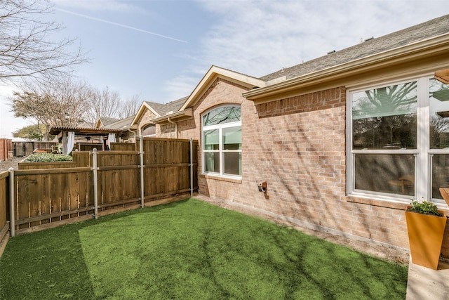 view of yard featuring fence and a pergola