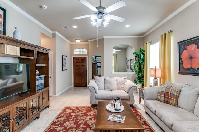 living area featuring arched walkways, ceiling fan, light tile patterned flooring, visible vents, and ornamental molding