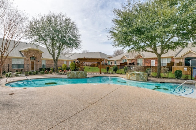 pool with a patio area, fence, and a residential view