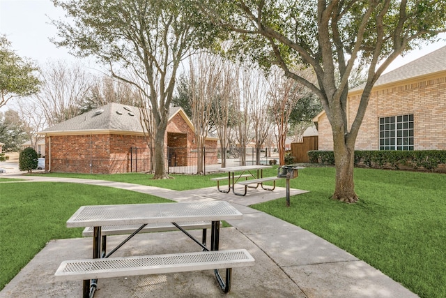 view of home's community featuring a yard and fence