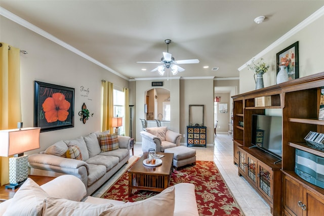 living area with arched walkways, recessed lighting, ornamental molding, light tile patterned flooring, and baseboards