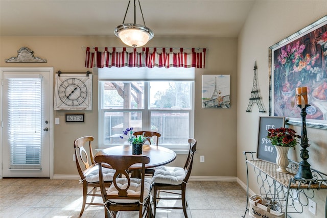 dining room with light tile patterned floors and baseboards