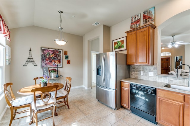 kitchen featuring a sink, visible vents, stainless steel refrigerator with ice dispenser, backsplash, and dishwasher