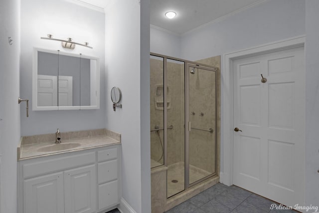 bathroom featuring ornamental molding, a shower stall, vanity, tile patterned flooring, and baseboards