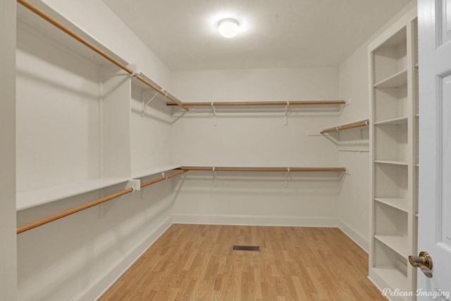 spacious closet with light wood-type flooring and visible vents