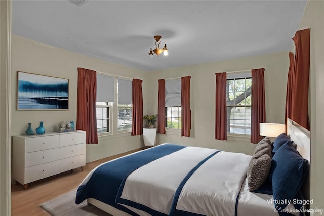 bedroom with light wood-type flooring