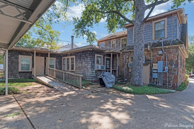 rear view of property featuring cooling unit