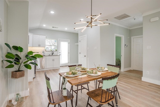 dining area with light wood-type flooring, visible vents, and baseboards