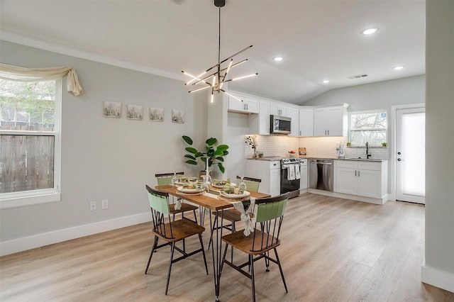 dining area with plenty of natural light, light wood-style flooring, and baseboards