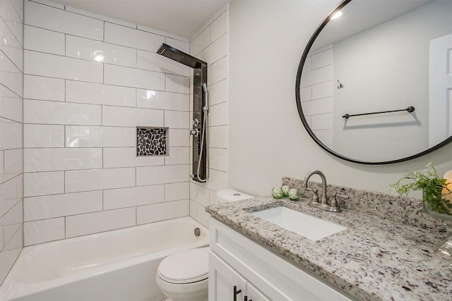 bathroom featuring washtub / shower combination, vanity, and toilet