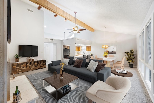 living room with light colored carpet, visible vents, beamed ceiling, and a textured ceiling