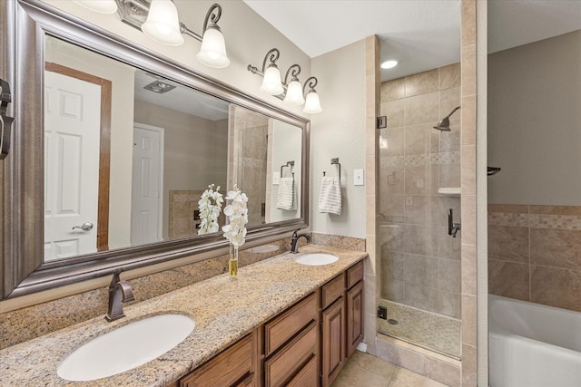 bathroom featuring a stall shower, a garden tub, a sink, and tile patterned floors