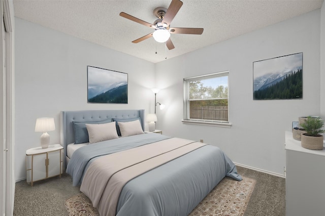 bedroom featuring a ceiling fan, carpet flooring, a textured ceiling, and baseboards