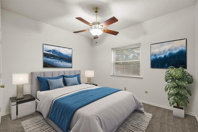 carpeted bedroom with ceiling fan, a textured ceiling, and baseboards