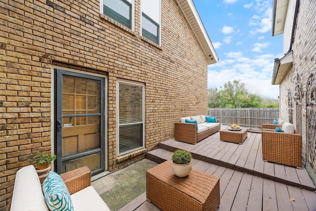 wooden deck featuring fence and an outdoor living space