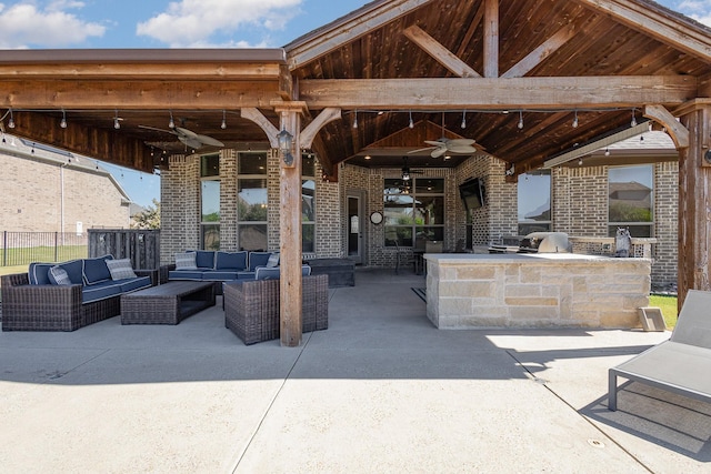 view of patio / terrace with an outdoor kitchen, grilling area, an outdoor hangout area, and a ceiling fan