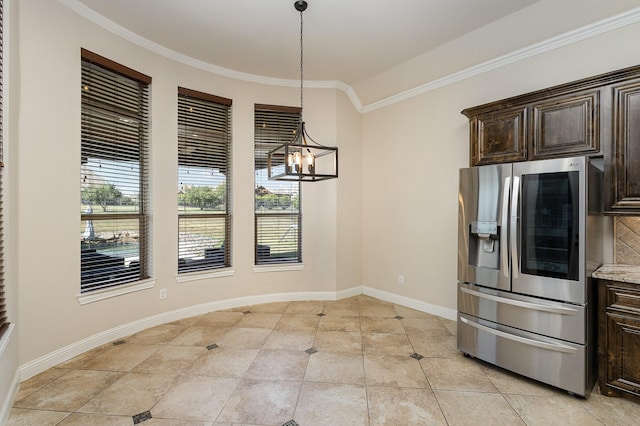 kitchen featuring crown molding, baseboards, dark brown cabinets, and stainless steel fridge with ice dispenser