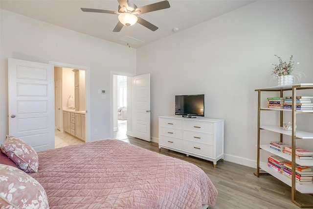 bedroom with a ceiling fan, light wood-style flooring, and baseboards